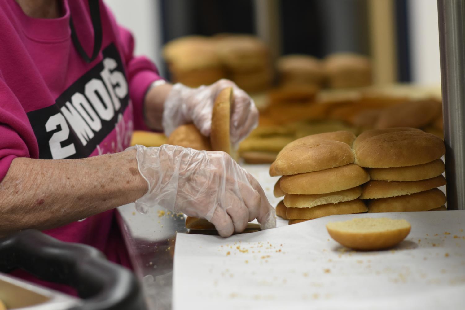 Kitchen staff member Mary Gaspard prepares sandwiches before lunch