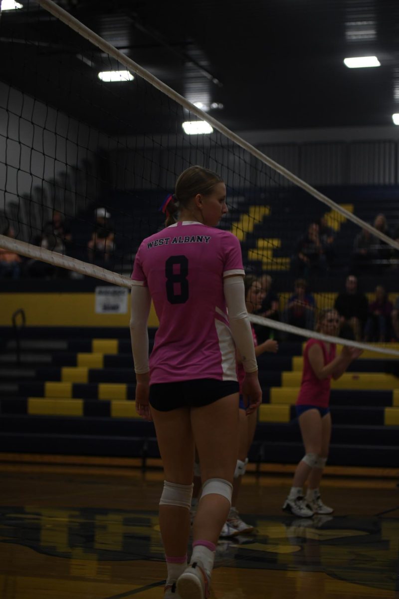 Senior and team captain Jenna Konzelman walking onto the court.