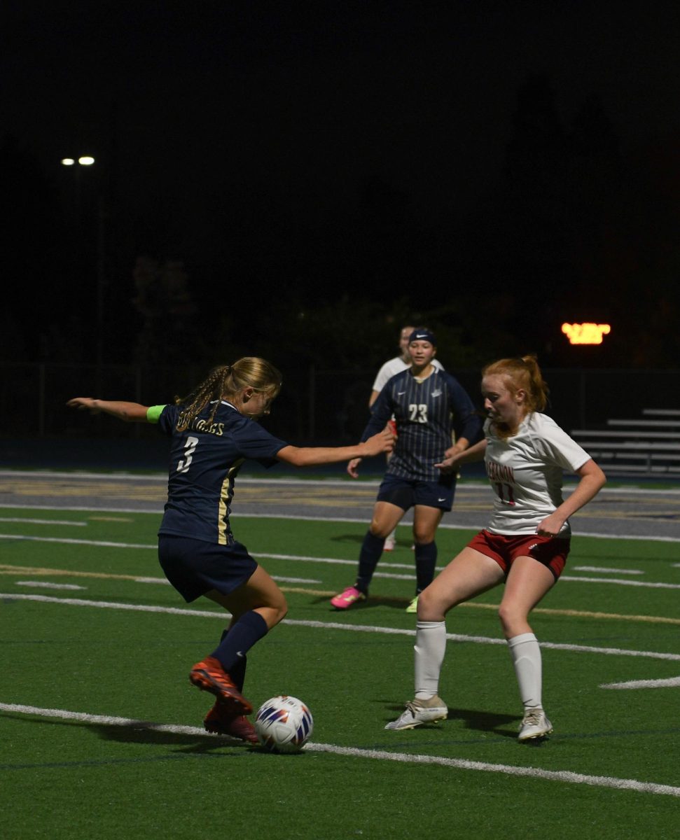 Senior team captain Haley Blaine passes the ball to senior Khobi Carmichael.