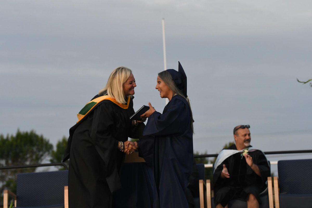 Mrs. Orsborn at class of 2023's graduation with WAHS alumni Taylor Lumpkin 