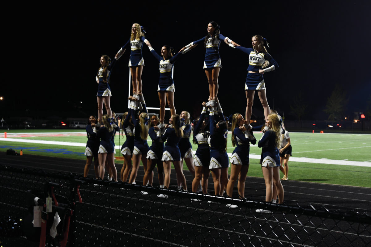 The renewed varsity cheer team performs during the rival game between the West Albany Bulldogs and the South Albany RedHawks at South Albany High School on Oct. 10.