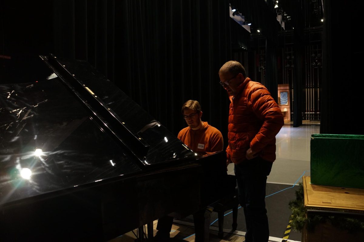 Stuart Welsh and David Nicholas inspecting the new piano.