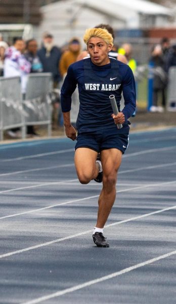 Senior Jonathan Fiscal in the last leg for the boys 4x400 on April 4.
