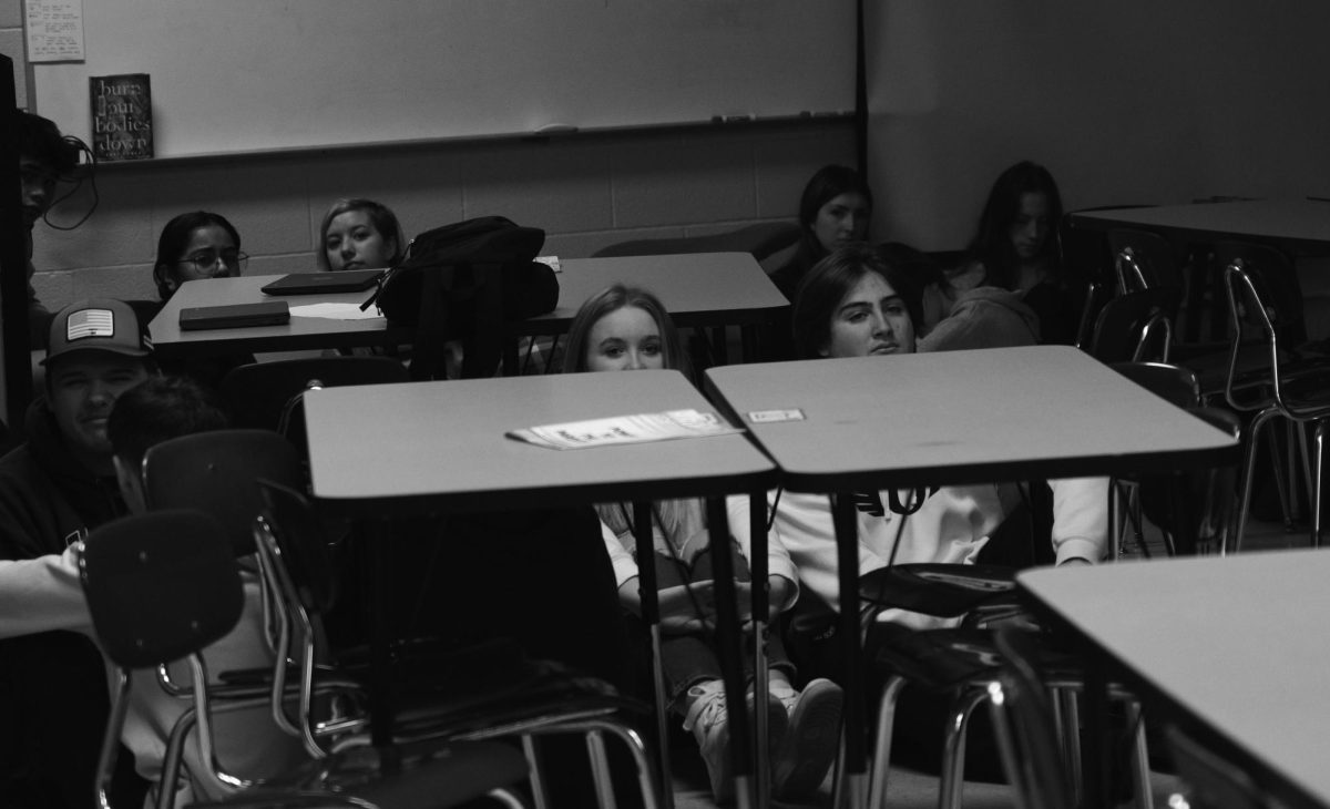 Seniors Milan Boyd and Sadie Tatum hide in classroom C9 during a lockdown drill during the 2023-24 school year 