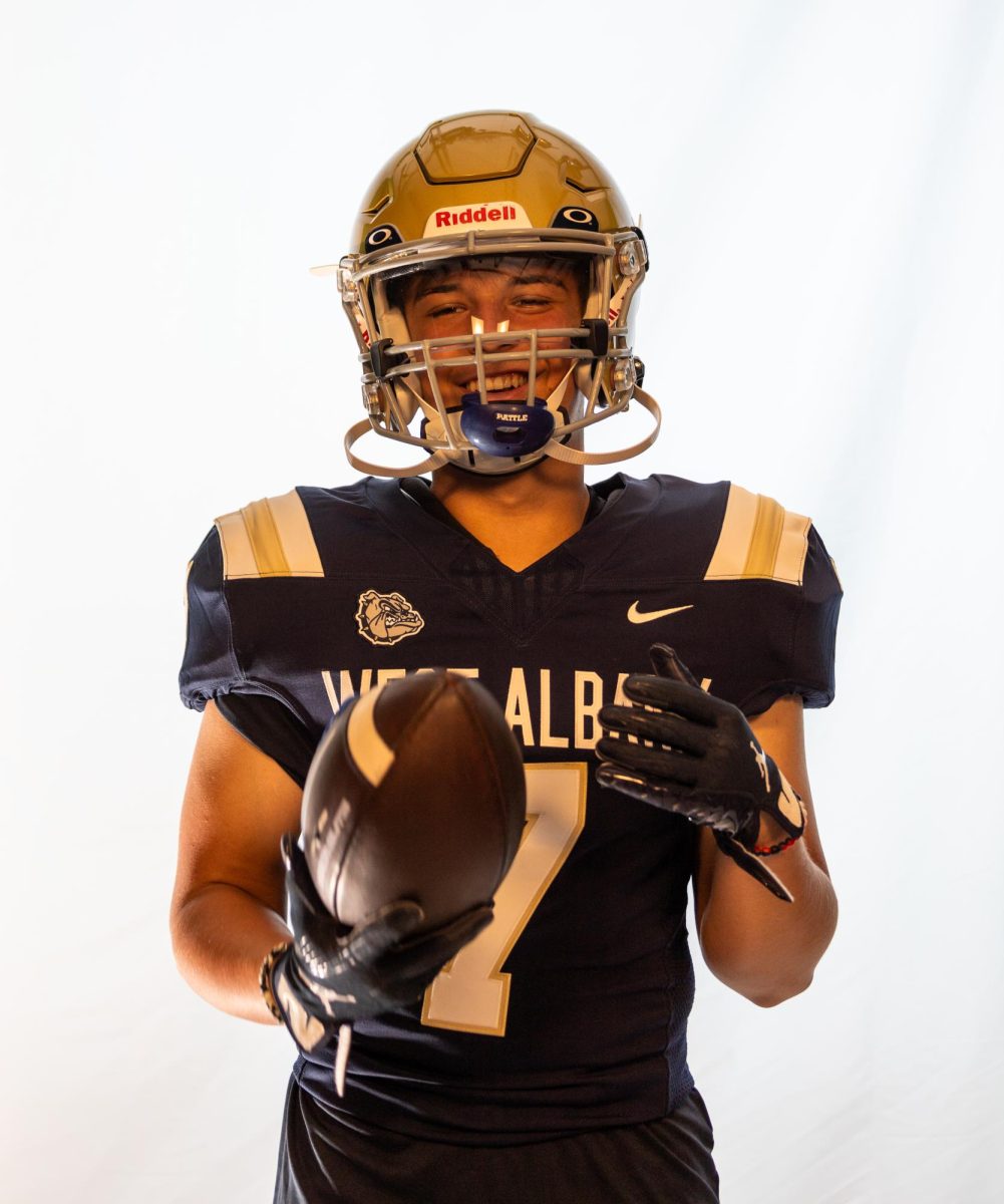 Senior defensive back Wyatt Morse shows off the new football uniforms that they received this school year. 