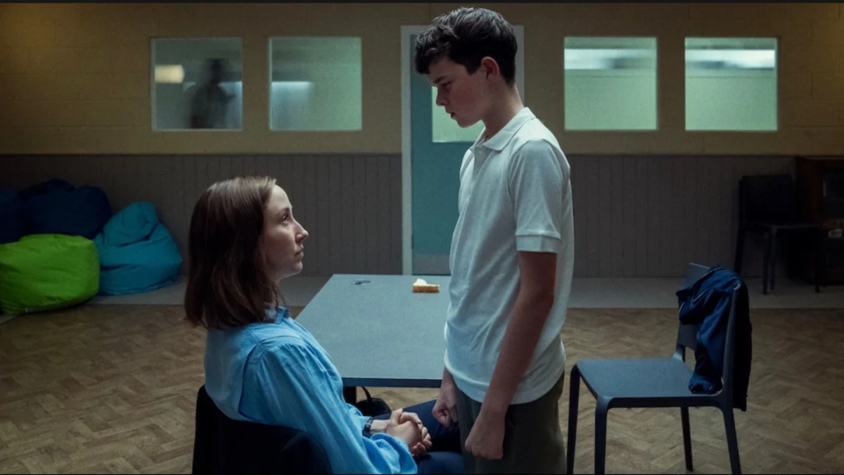 Jamie Miller (Owen Cooper) standing in defiance to therapist Briony Ariston (Erin Doherty) 