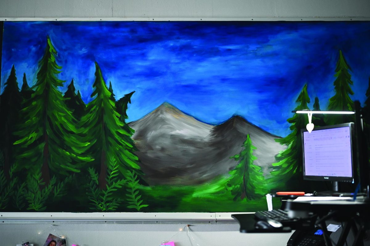Rasmussen's nature mural behind her desk