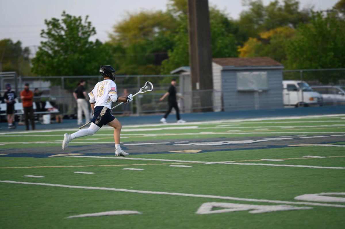 Sophomore Lucian Sukhdeo possesses the ball in transition from offense to defense